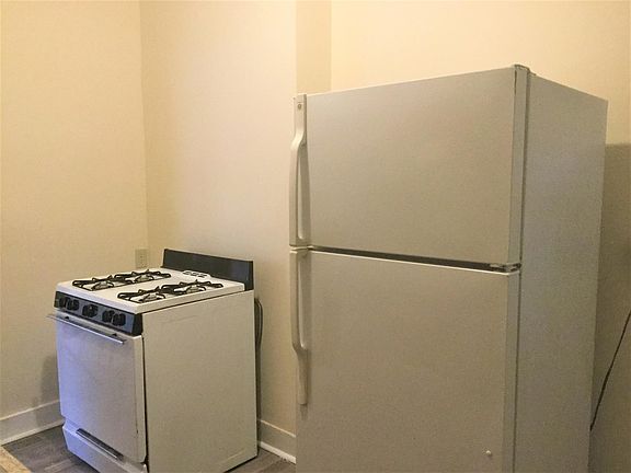 Spacious galley kitchen, with gas stove and full refrigerator.