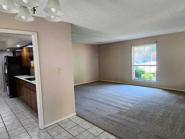 VIEW OF LIVING ROOM AND KITCHEN FROM THE PATIO EATING AREA