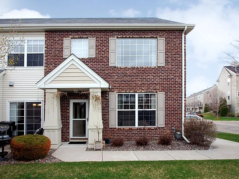 Front entrance with private patio to the left.
