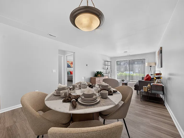 Open concept Living-Dining Area with natural lighting at Lakeside Village Apartments Clinton Township, MI