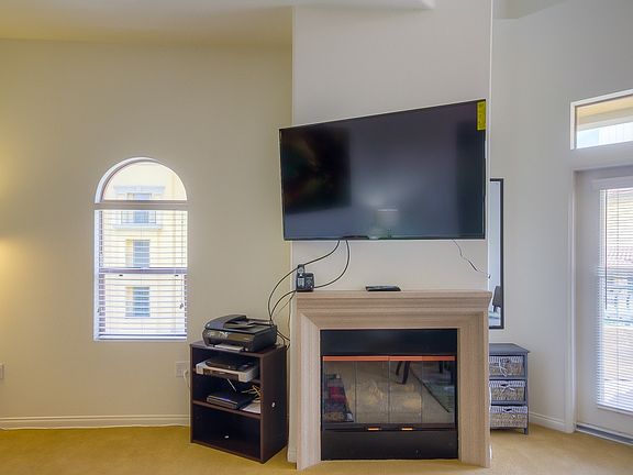 55" Smart Plasma TV in living room over cozy fireplace