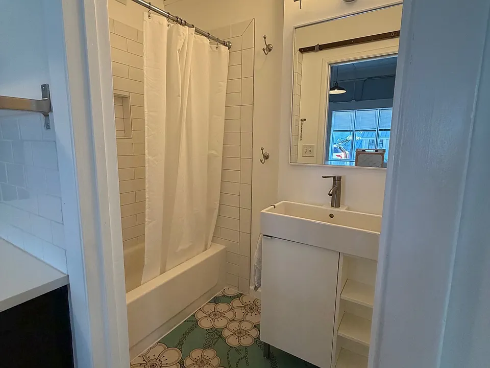 Bathroom with imported luxury flower blossom vinyl from Atrafloor from England, subway tile and smaller tub, tin ceilings