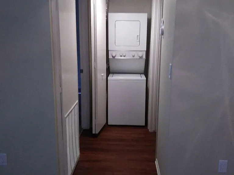 In-unit stacked washer and dryer in apartment at Teton Pines Apartments in Escondido, California.