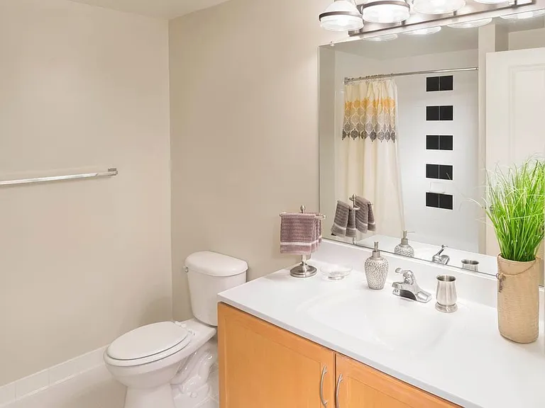 Bath with white countertop and tiled tub
