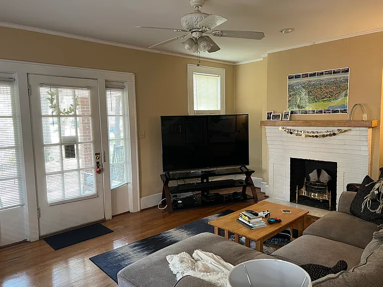 LIVING ROOM. FIREPLACE has gas burning coals in imported brass & steel English grate. Tenants say it's not only cozy but heats the room nicely when weather turns chilly.