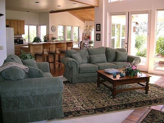 Family room overlooking kitchen, kitchen nook area and tranquil views