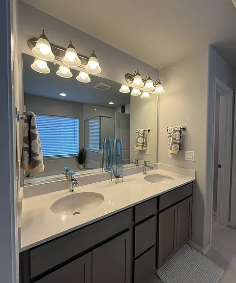 Master bath with quartz countertops, drawers and cabinets