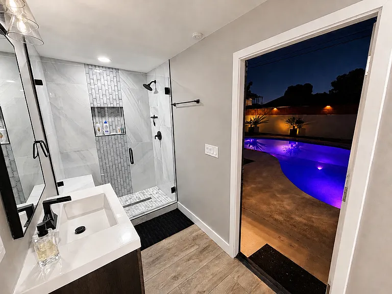 Large private pool bathroom opens to the backyard