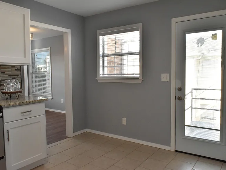 Kitchen showing private entry and leading to living room
