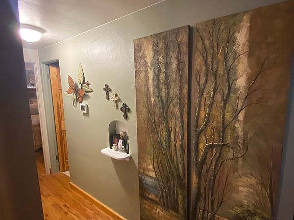 Unit hallway leading to bathroom and bedrooms.