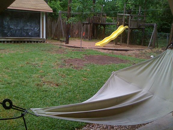 Garden shed with "porch", sturdy play structure keep kids busy so Mom can rest