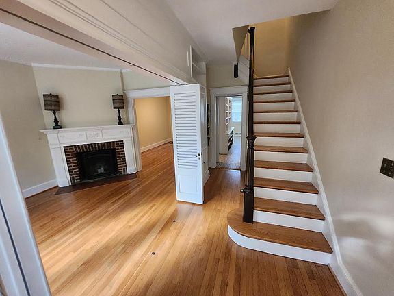 Entry way with stairs to second floor, kitchen, and living room to the left