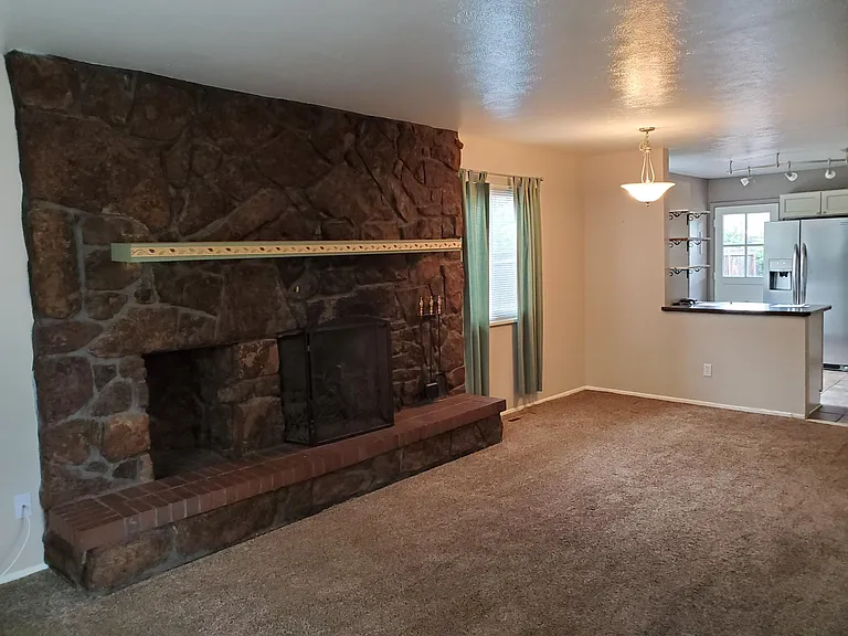 Living room working gas fireplace. House no longer has carpet - now has new luxury vinyl flooring.