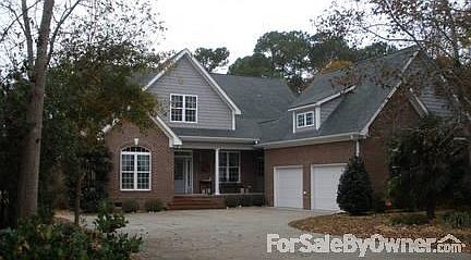 Home Front with wide driveway
						:
						Front entrances to foyer and mud room; large 2-car garage with upper storage.