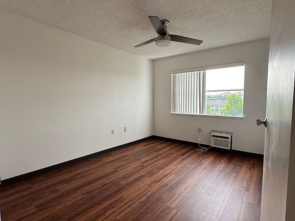 Primary bedroom with AC and ceiling fan