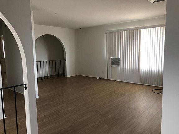 Living room with new paradigm flooring and window air