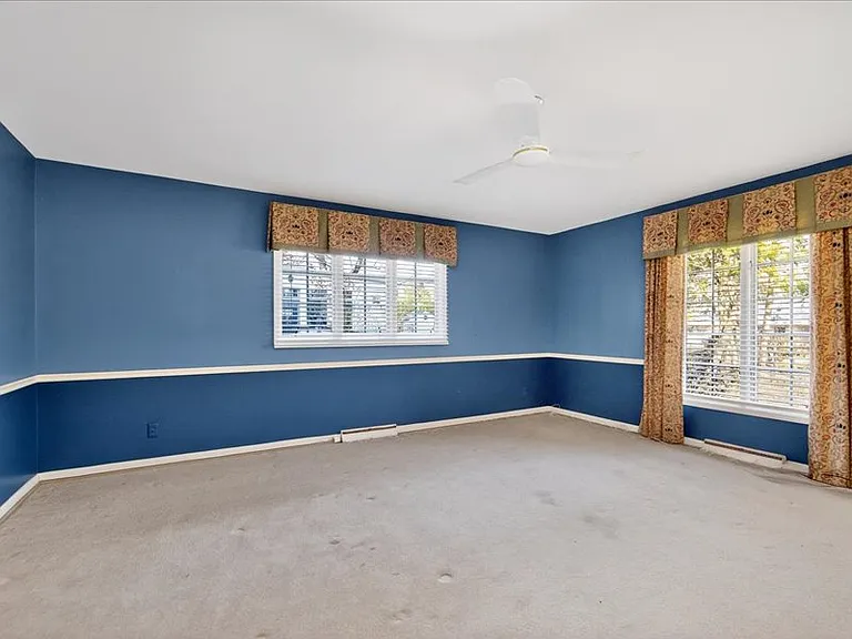 Primary bedroom with large windows