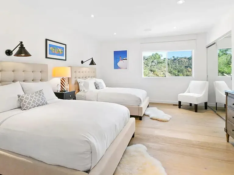Large guest bedroom equipped with 2 Queen beds with views of Beverly Hills.