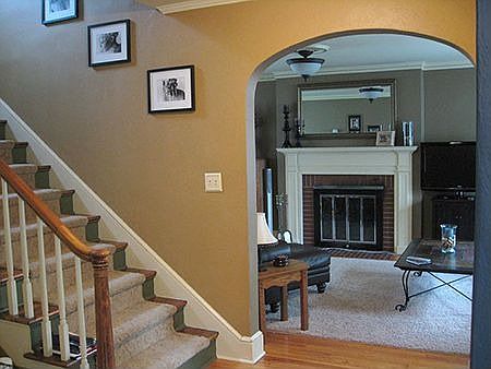 beautiful open stairway, arched doorways, working fireplace + hardwood floors