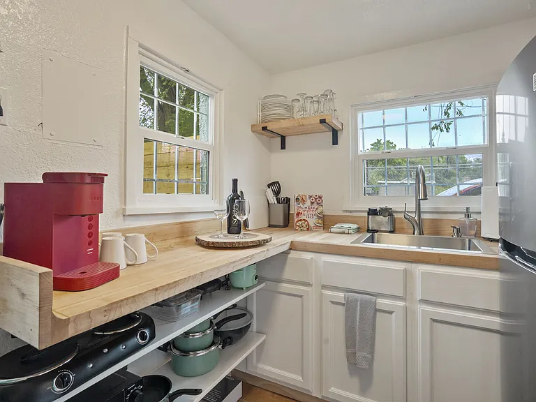Perfect for light cooking with a full-size fridge, microwave, hot plate, and essentials.