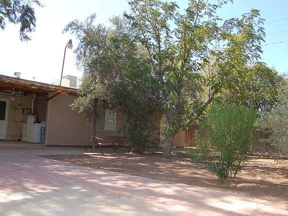 large paved area in backyard, car accessible