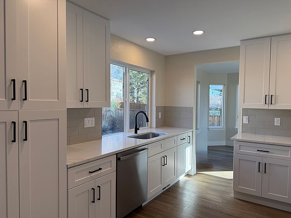 Large kitchen sink, quartz counters, new backsplash, new paint, new cabinets, new flooring.