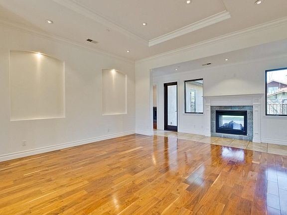 Living room with double side fireplace and access to courtyard