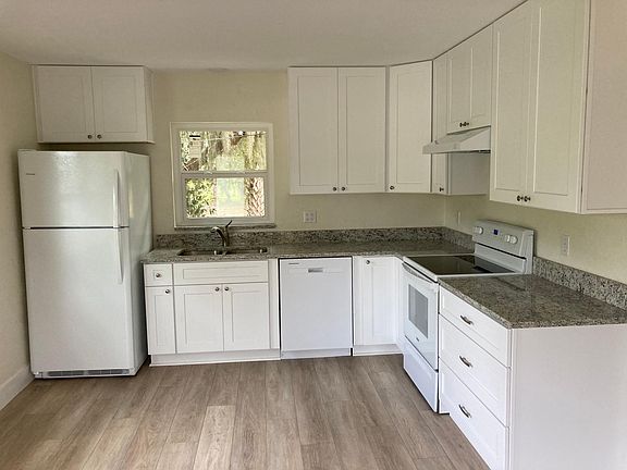 Large kitchen with all new custom cabinets, granite countertops, and appliances (refrigerator, stove, dishwasher, and garbage disposal).