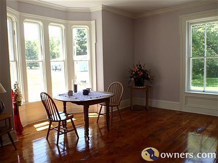 Front room with bay window, hardwood floors