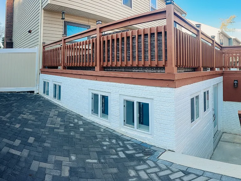 Exterior stairway and private entrance area leading down to the apartment.