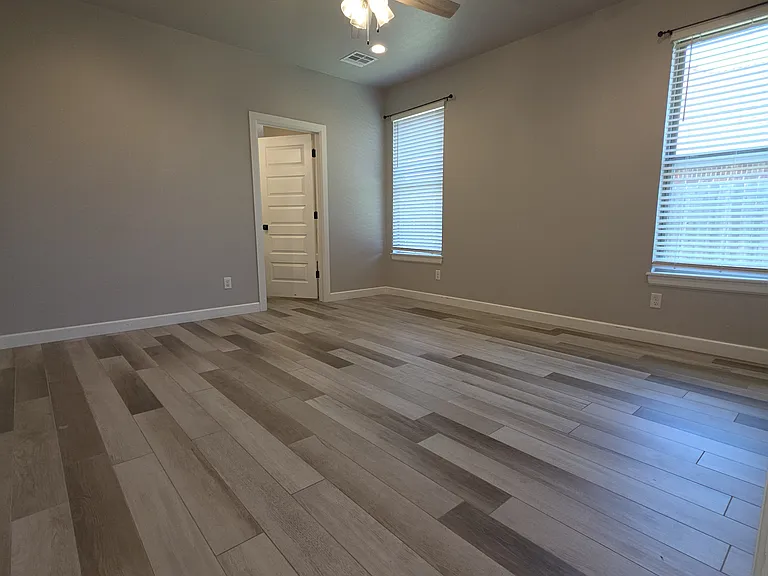 The Master/Primary Suite features a full bath, tile floors & quartz & porcelain wall tile countertops.