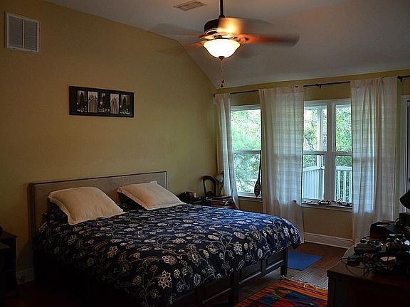 Adorable master suite with a lovely balcony.