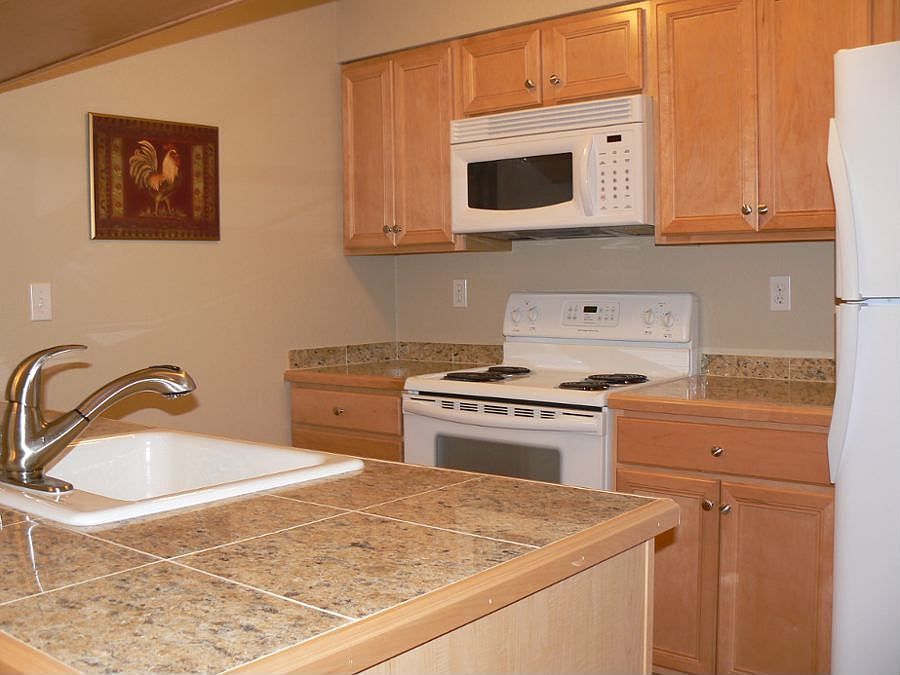 Kitchen features granite counters and new maple cabinetry.