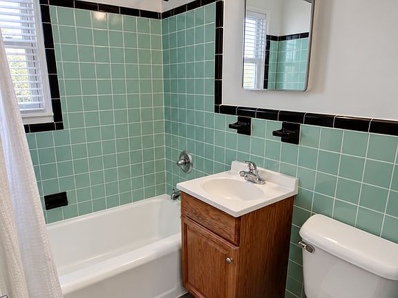 Mint-Tiled Bathroom with White Blind