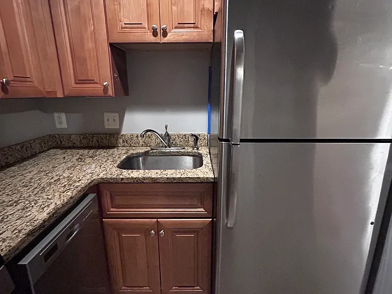 Kitchen stainless steel refrigerator and freezer, granite cabinets