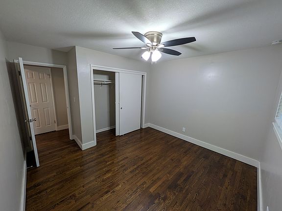 Open bedroom with ceiling fan