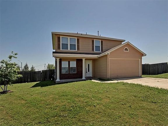 Very nice, traditional home with a covered porch with columns. It has a long driveway and is located on a large lot.