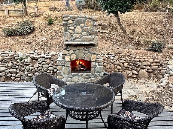 Custom brand new outdoor fireplace. Enjoy your evenings by the fire just outside the master bedroom.