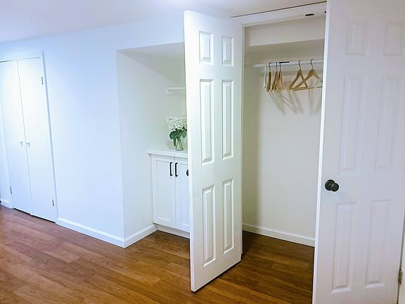 Bedroom has a large closet and built-in bookshelves with storage underneath.