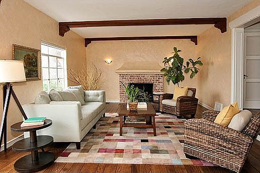 Elegant living room with Bay views, fireplace and random-plank hardwood floors