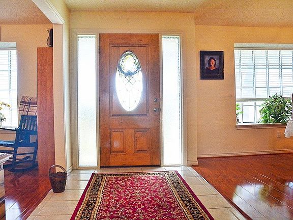 Large entry with living area to one side and dining with built ins on other side