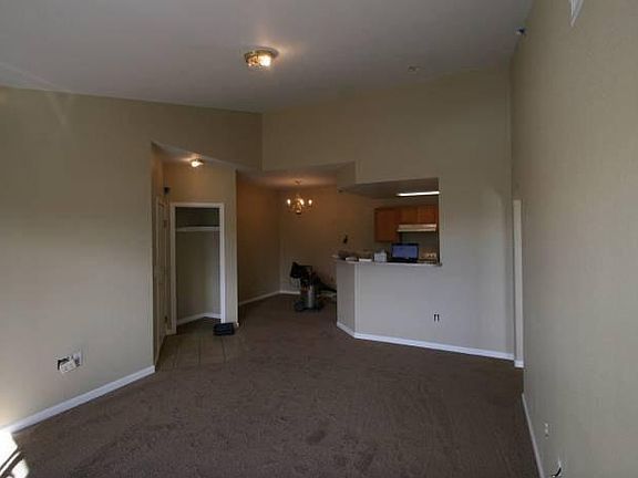 The living room has a ceiling fan with a light.