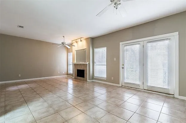 Large and open Living Room with a fireplace and ceiling fans.