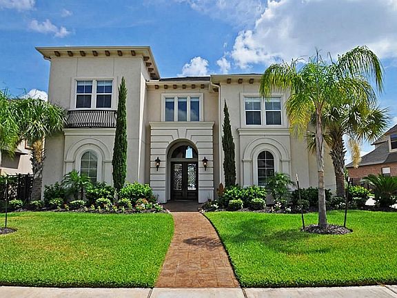 THIS ELEGANT STUCCO HOME WHICH HAS GREAT CURB APPEAL AND LUSH LANDSCAPING.