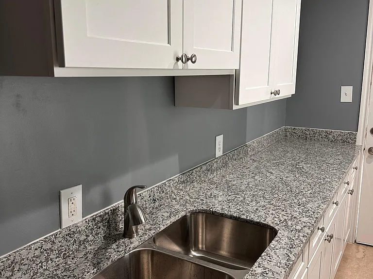 Kitchen with granite countertops. Brand new appliances (refrigerator, stove, washer, dryer) to be installed this month. You'll be the first tenant in this remodeled unit.