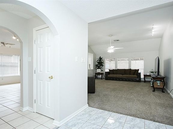 To the left is your spacious kitchen. Just walk through the double arches! Straight ahead is your huge living space.