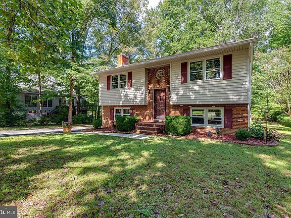 Large front yard with landscaped beds