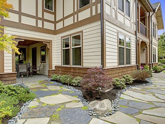 all new flagstone pathways, lush landscaping, outdoor lighting and re-grading really compliment the Tudor Revival architecture
