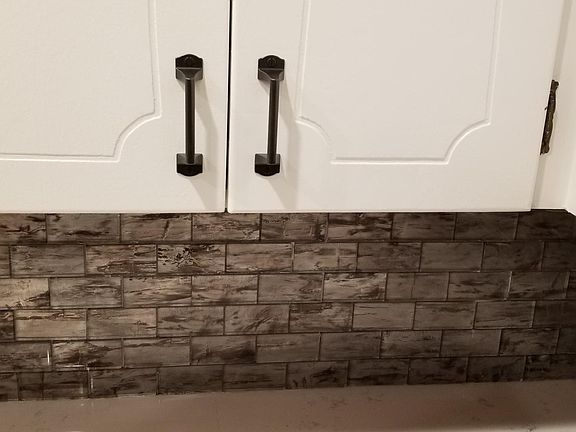 The kitchen had impressive hardware and an even more impressive glass tile backsplash.