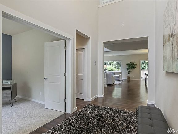 Enter to soaring ceilings and gorgeous engineered hardwood floors! To the left off of the entry find a den / office with double door entry. 